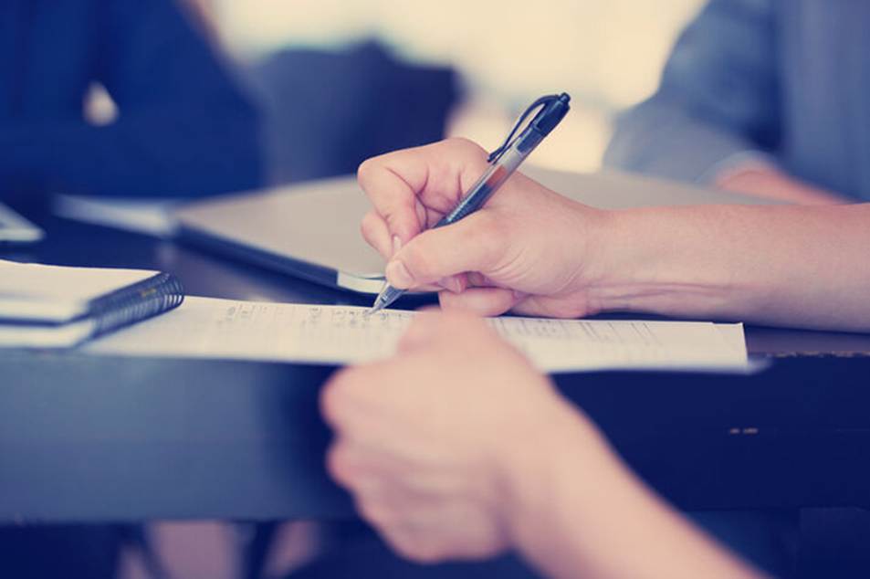 A hand uses a pen to edit text on a page. This image shows an editor using a "Blue Pen" in a content management system.